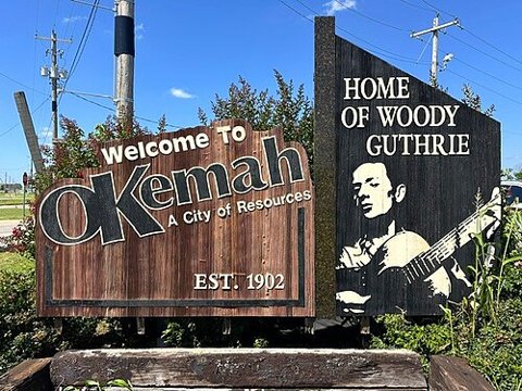 An Okemah town sign — location context